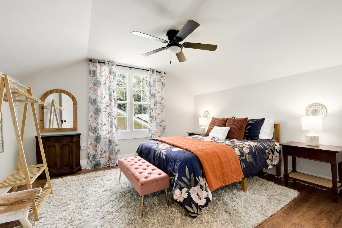 712 East 44th Street, Unit A Austin, TX 78751 - Photo 35 of 40 a bedroom with a bed a fireplace and a chandelier