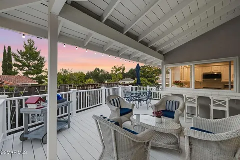 a view of balcony with furniture and wooden floor