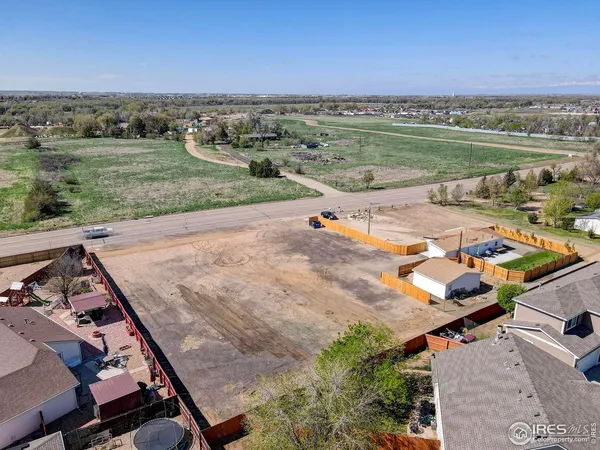 an aerial view of a house with a yard basket ball court and outdoor seating
