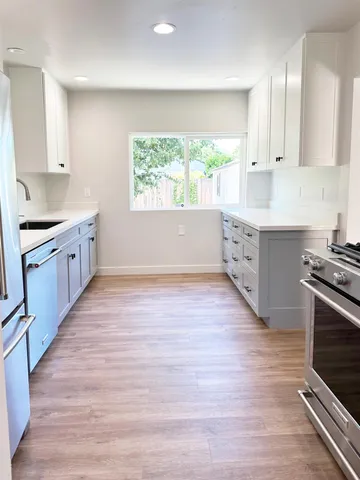 a kitchen with a sink cabinets and stainless steel appliances