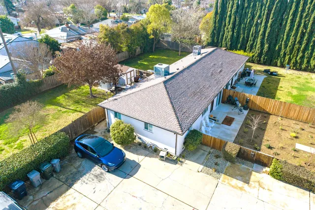 a view of a house with backyard and sitting area