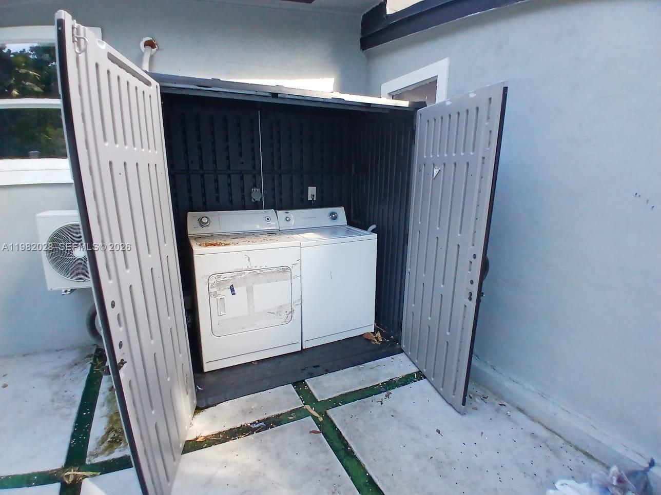 1053 Northeast 149th Street Miami, FL 33161 - Photo 11 of 13 a view of a storage and utility room with washer and dryer