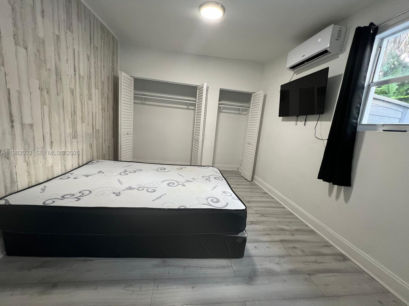 1053 Northeast 149th Street Miami, FL 33161 - Photo 3 of 13 a view of a living room with a flat screen tv