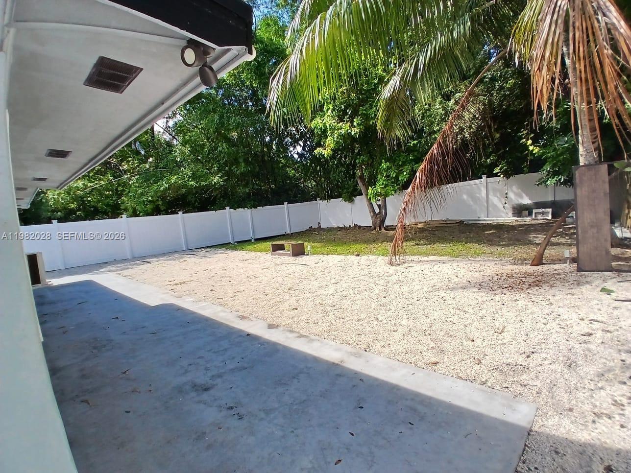 1053 Northeast 149th Street Miami, FL 33161 - Photo 10 of 13 a view of a backyard with palm trees