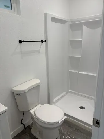 a bathroom with a toilet and a shower