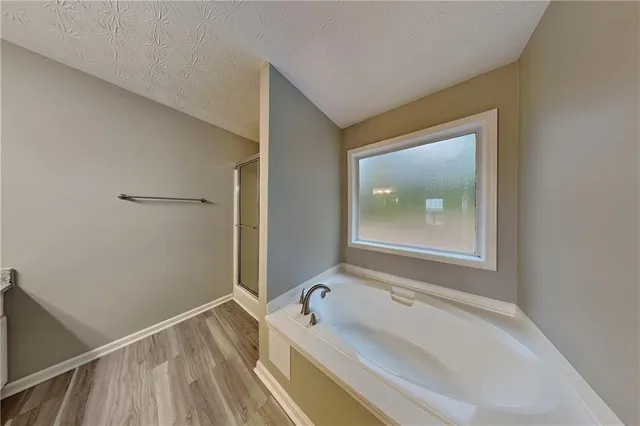 a bathroom with a tub and a sink