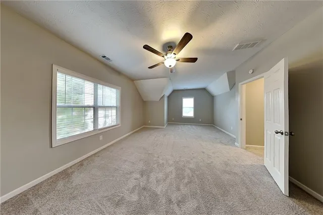 a view of a livingroom with a ceiling fan and window