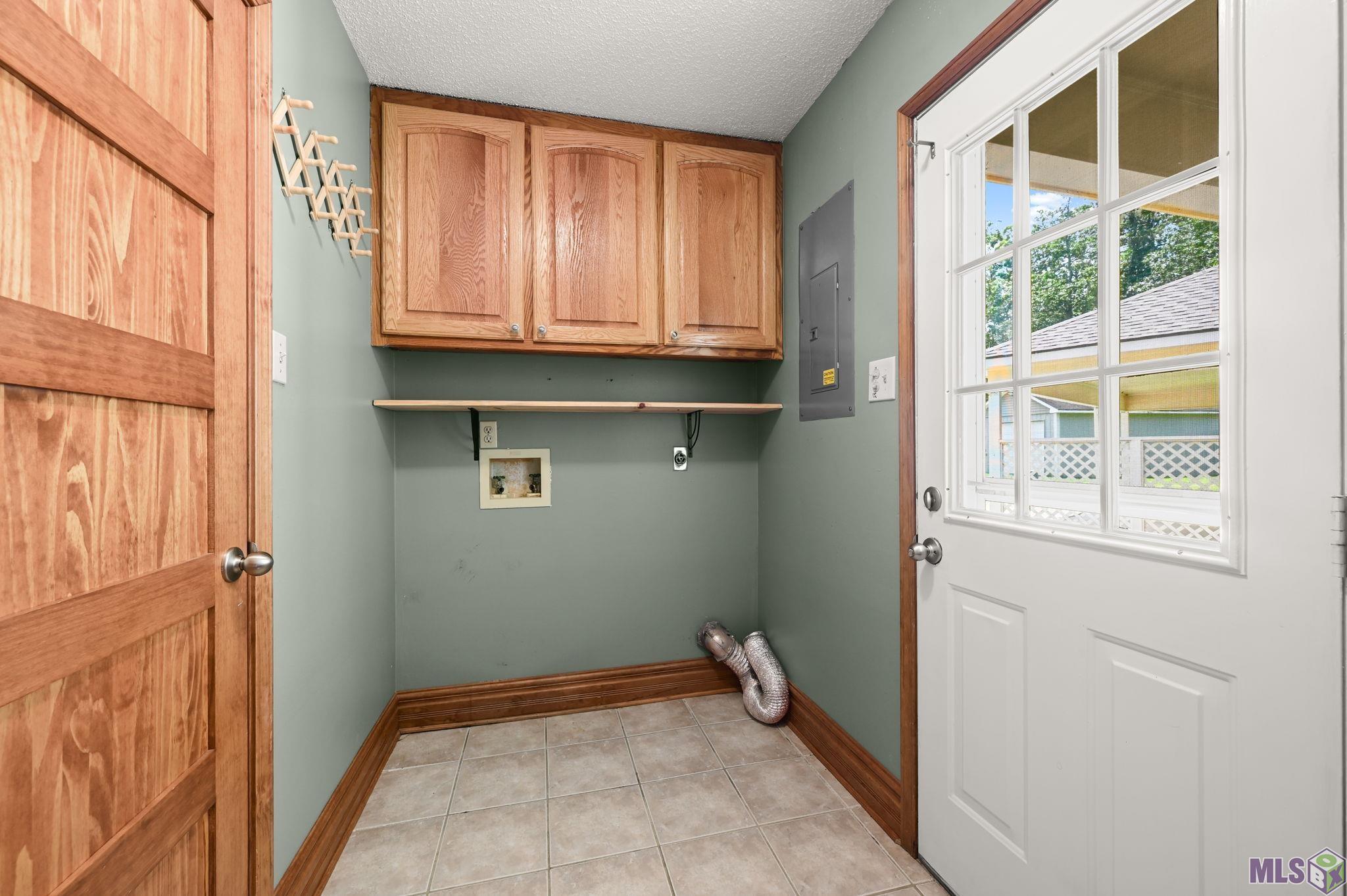 7097 Jim Rushing Road Denham Springs, LA 70706 - Photo 8 of 28 Laundry room with Pantry shelving