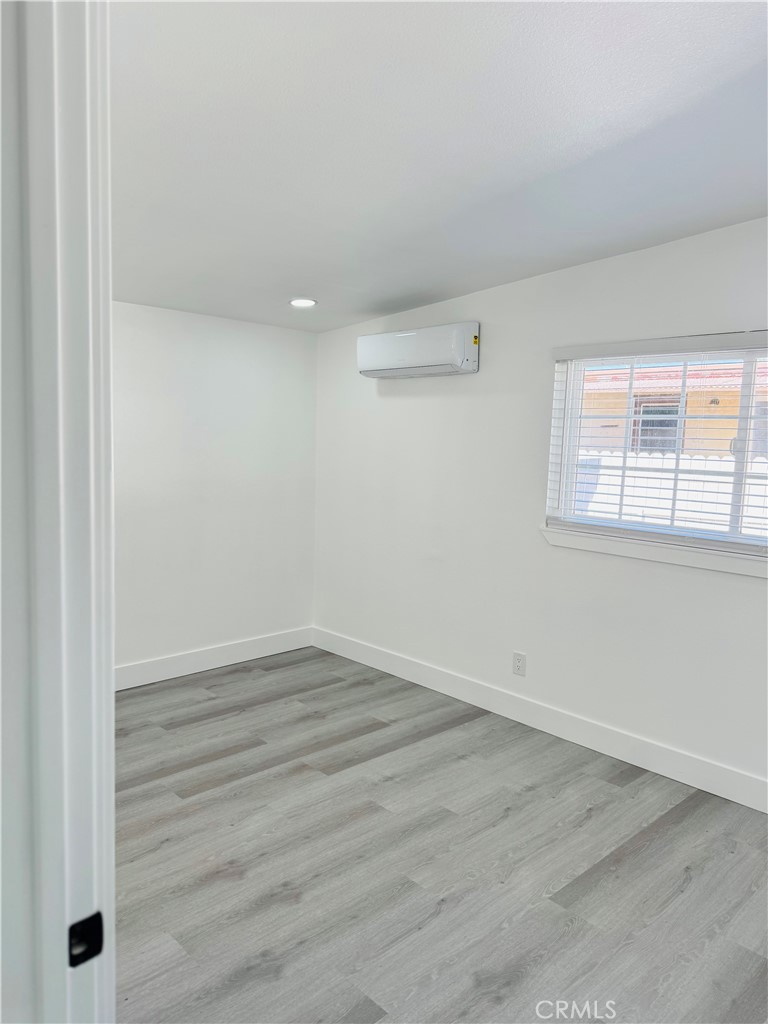9314 Martha Way Riverside, CA 92503 - Photo 13 of 25 an empty room with wooden floor and windows