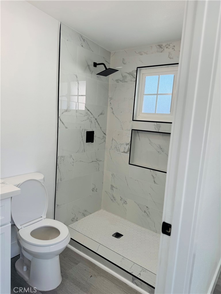 9314 Martha Way Riverside, CA 92503 - Photo 14 of 25 a bathroom with a shower a toilet and a sink