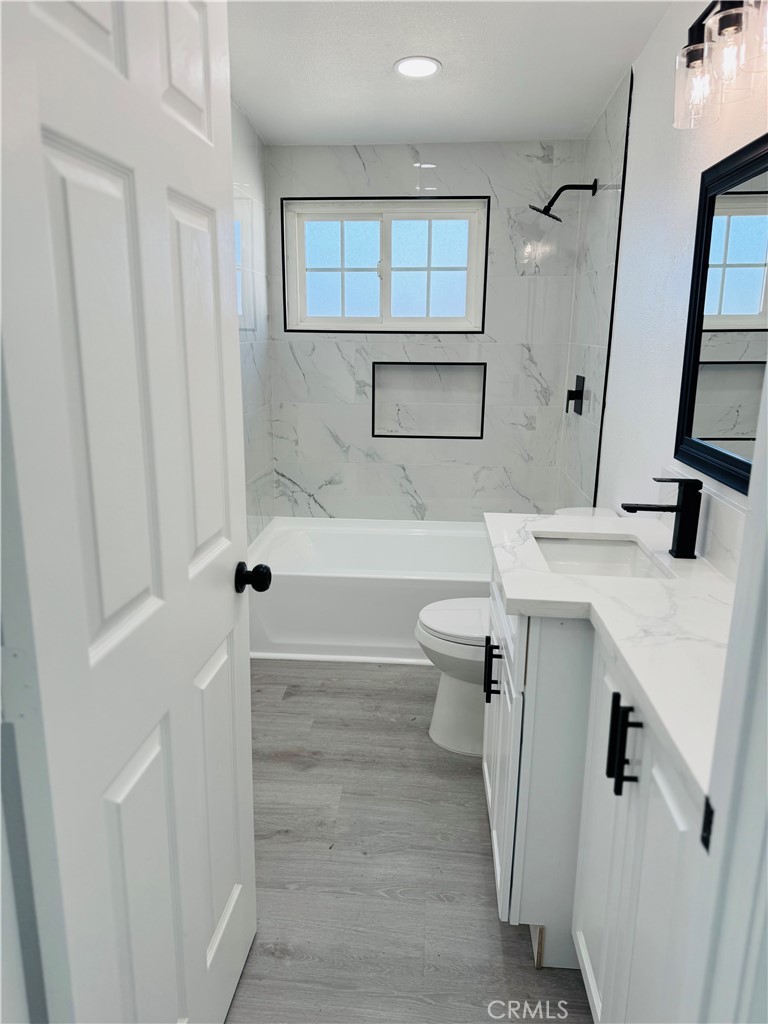 9314 Martha Way Riverside, CA 92503 - Photo 18 of 25 a bathroom with a sink a toilet and shower