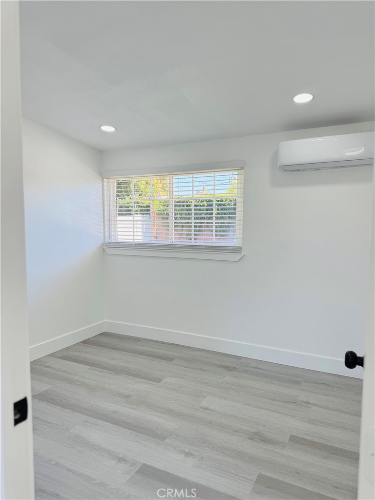 9314 Martha Way Riverside, CA 92503 - Photo 19 of 25 an empty room with wooden floor and windows