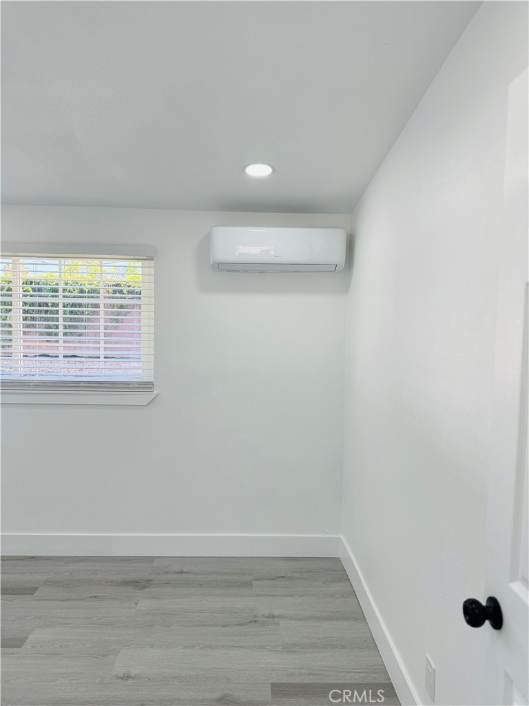 9314 Martha Way Riverside, CA 92503 - Photo 21 of 25 a view of an empty room with wooden floor and a window