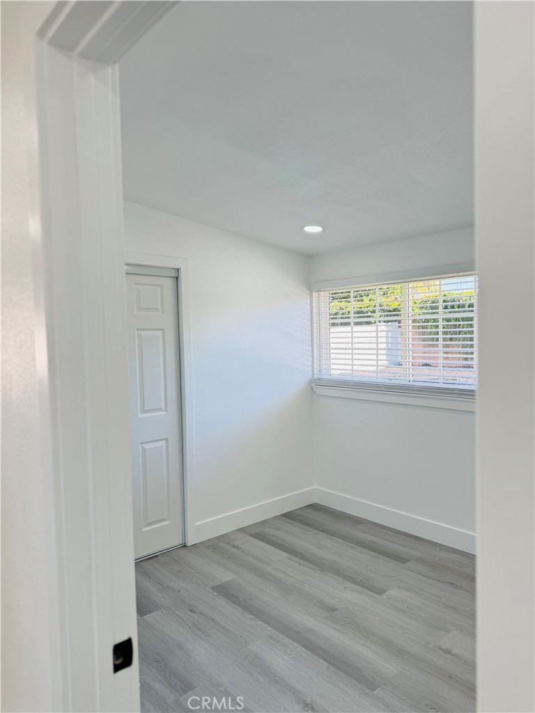 9314 Martha Way Riverside, CA 92503 - Photo 22 of 25 an empty room with wooden floor and windows