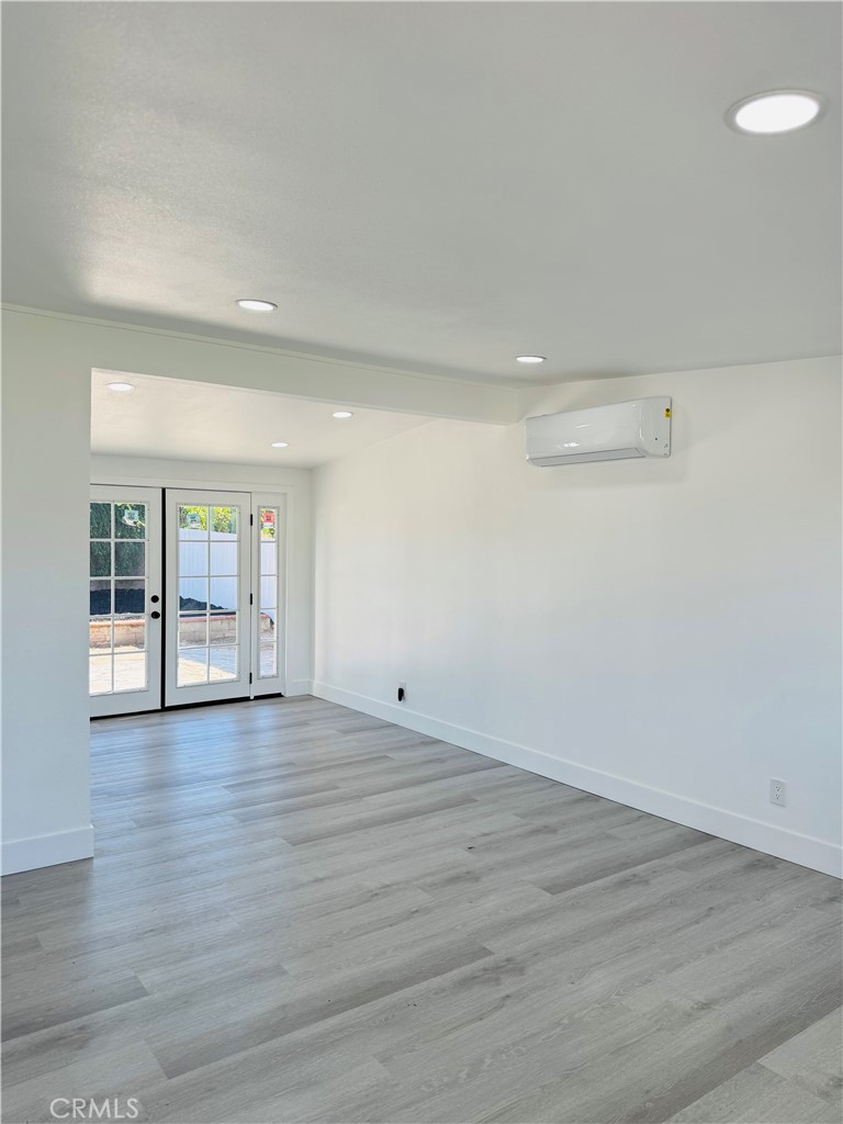 9314 Martha Way Riverside, CA 92503 - Photo 25 of 25 an empty room with wooden floor and windows