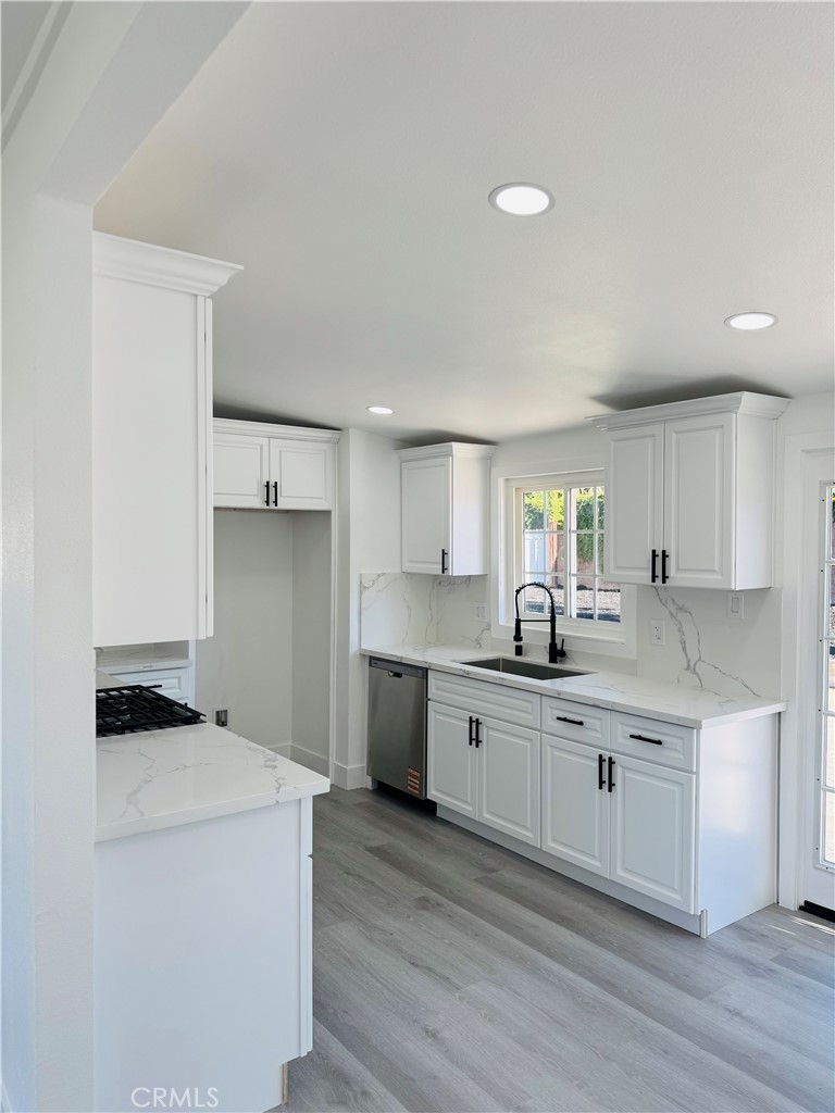 9314 Martha Way Riverside, CA 92503 - Photo 9 of 25 a kitchen with a sink cabinets and wooden floor