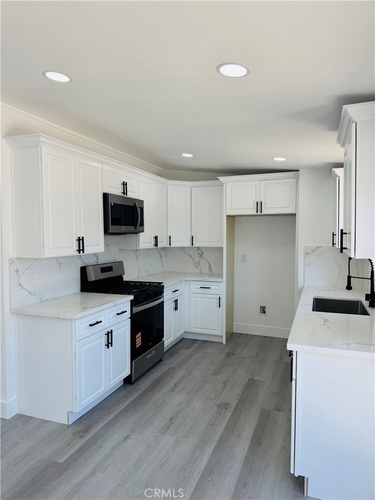 9314 Martha Way Riverside, CA 92503 - Photo 10 of 25 a kitchen with a stove a sink and a refrigerator