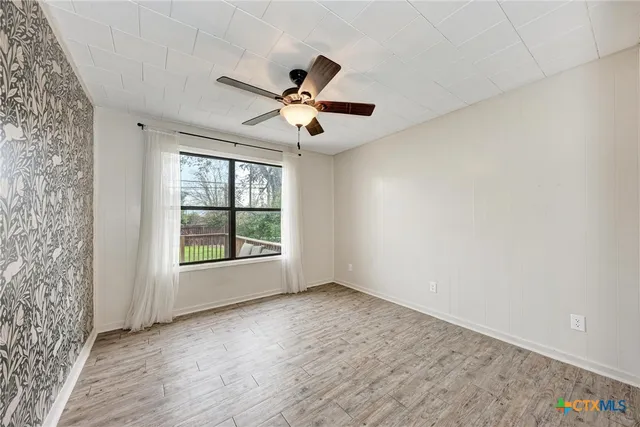 wooden floor in an empty room with a window