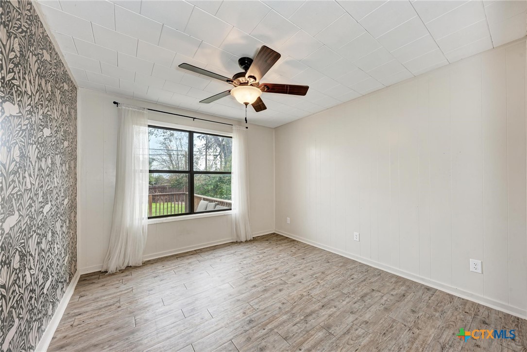 501 North Ridge Street Lampasas, TX 76550 - Photo 16 of 46 wooden floor in an empty room with a window