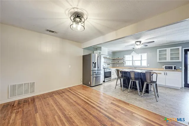 a view of a dining room with furniture and wooden floor