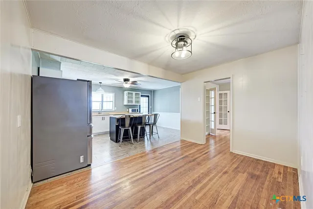 a view of a dining room with furniture and a chandelier