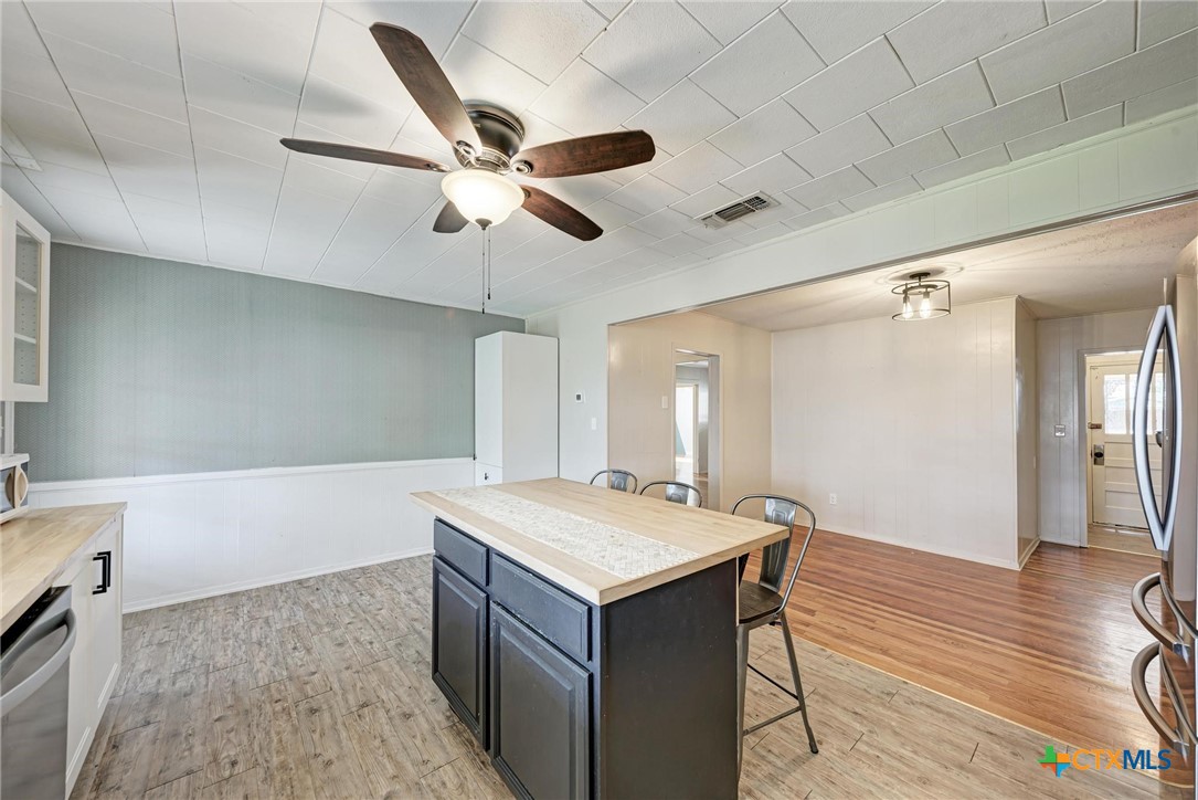 501 North Ridge Street Lampasas, TX 76550 - Photo 23 of 46 a room with a chandelier and wooden floor