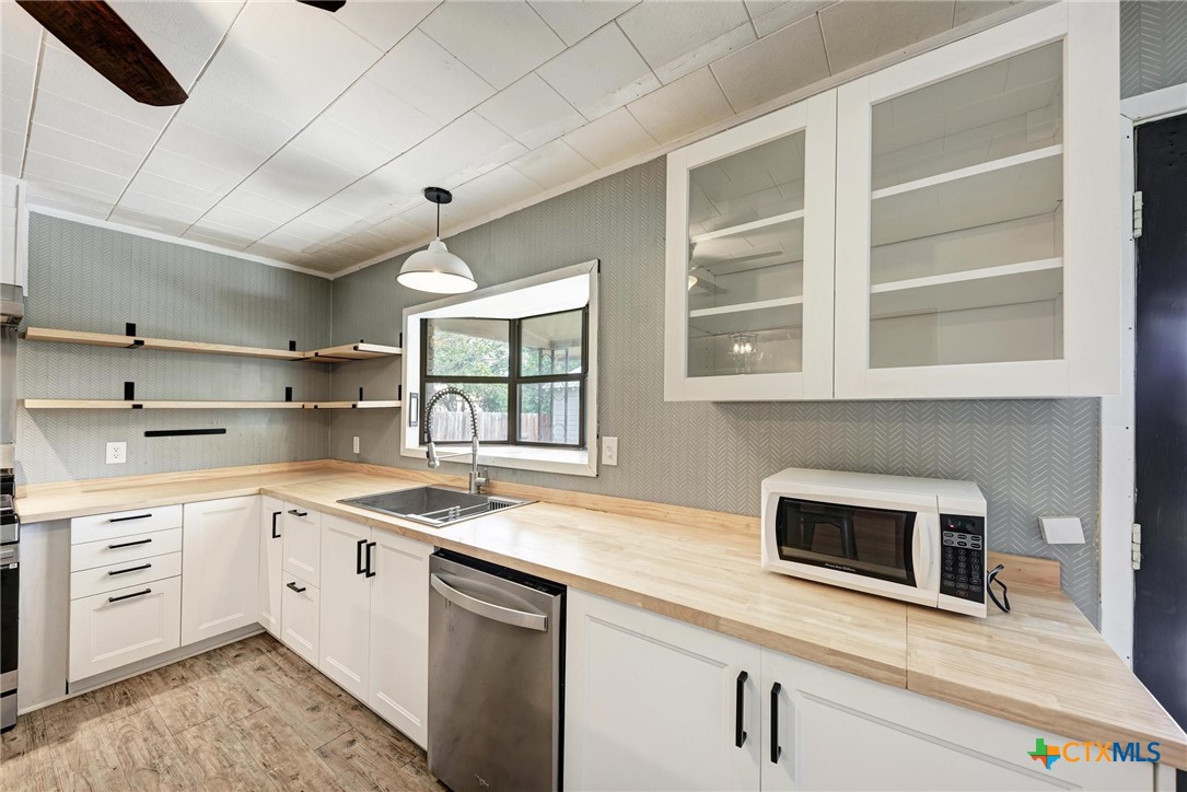 501 North Ridge Street Lampasas, TX 76550 - Photo 24 of 46 a kitchen with a sink stove and microwave
