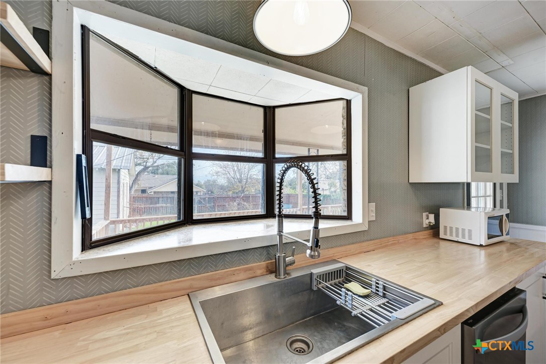 501 North Ridge Street Lampasas, TX 76550 - Photo 25 of 46 a kitchen with a stove a sink and a window