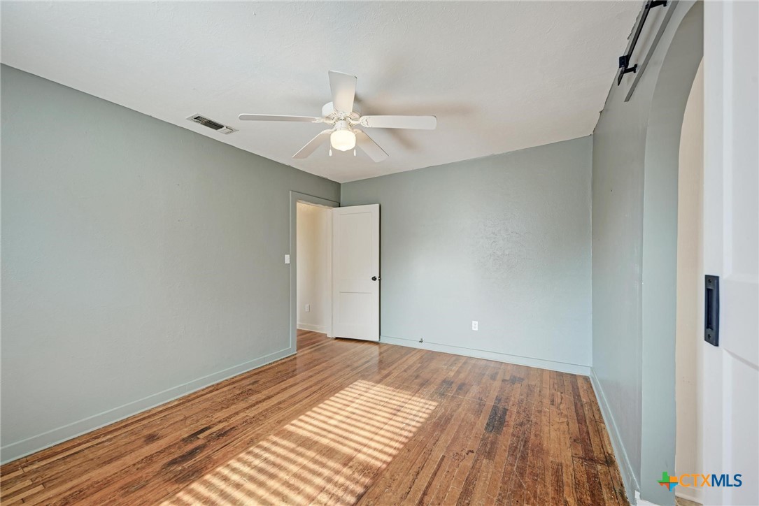 501 North Ridge Street Lampasas, TX 76550 - Photo 28 of 46 a view of a room with wooden floor and ceiling fan