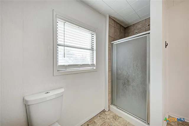 a bathroom with a shower and toilet