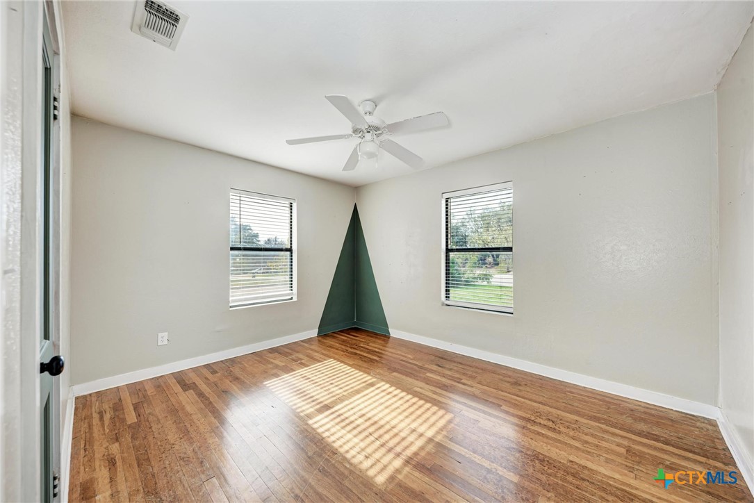 501 North Ridge Street Lampasas, TX 76550 - Photo 31 of 46 a view of an empty room with a window and wooden floor