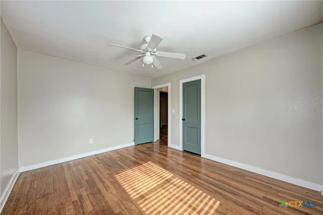 a view of a big room with wooden floor and closet