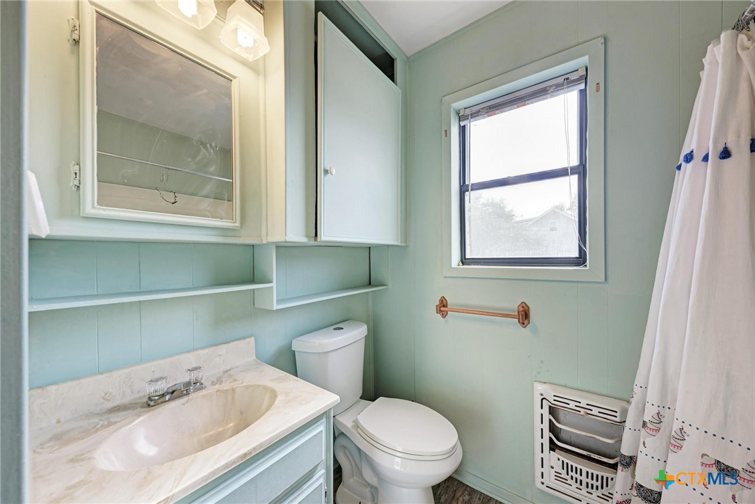 501 North Ridge Street Lampasas, TX 76550 - Photo 33 of 46 a white toilet sitting next to a bathroom sink