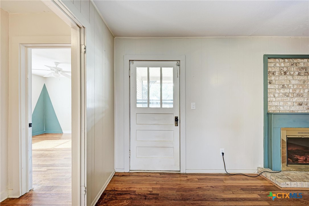 501 North Ridge Street Lampasas, TX 76550 - Photo 9 of 46 a view of a livingroom with wooden floor and a fireplace