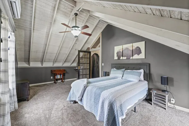 a bedroom with a bed a desk and chair