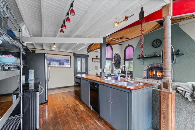 a kitchen with lots of counter top space and wooden floor