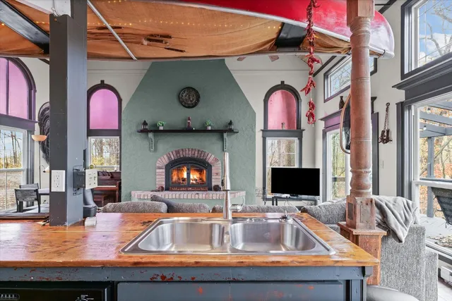 a view of living room with furniture and a fireplace