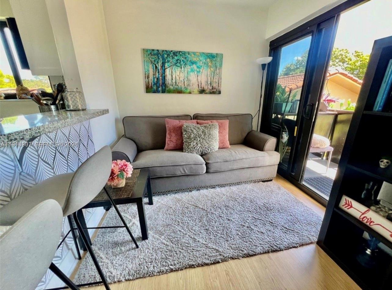 3520 Southwest 25th Street, Unit 3520 Miami, FL 33133 - Photo 12 of 18 a living room with furniture and a flat screen tv