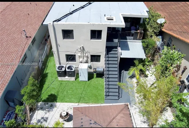 a view of a house with a yard porch and furniture
