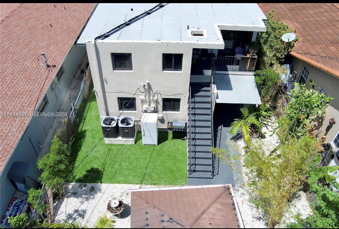 3520 Southwest 25th Street, Unit 3520 Miami, FL 33133 - Photo 17 of 18 a view of a house with a yard porch and furniture