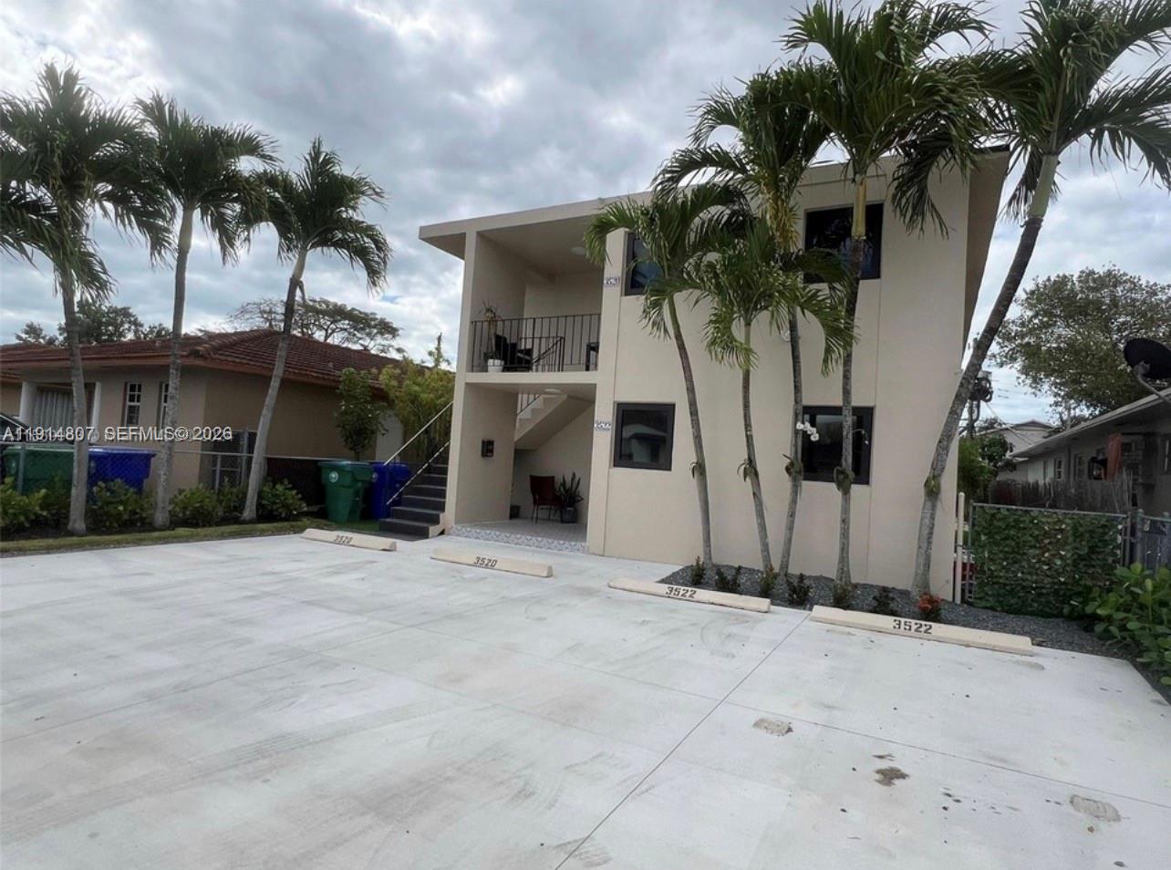 3520 Southwest 25th Street, Unit 3520 Miami, FL 33133 - Photo 3 of 18 a front view of a house with a yard and garage