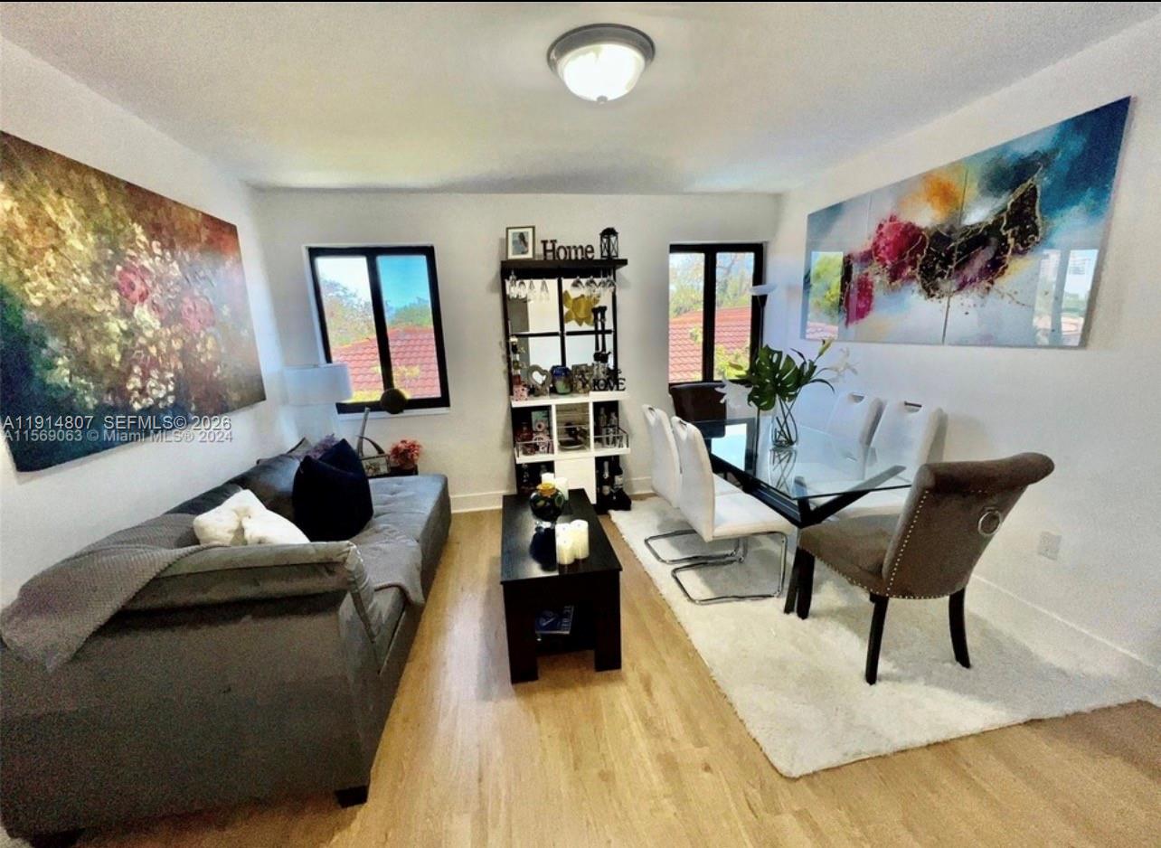 3520 Southwest 25th Street, Unit 3520 Miami, FL 33133 - Photo 10 of 18 a living room with furniture and a flat screen tv with potted plant