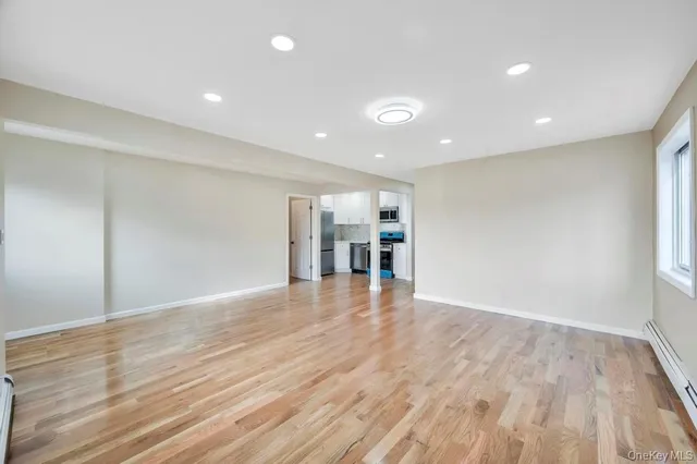 a kitchen with granite countertop a stove top oven and refrigerator