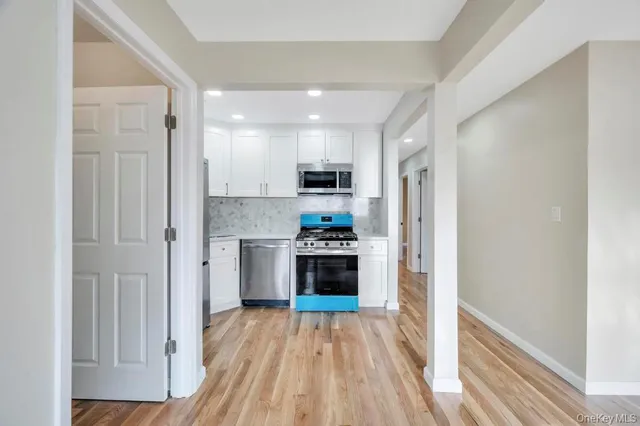 a kitchen with stainless steel appliances granite countertop a refrigerator stove top oven and sink