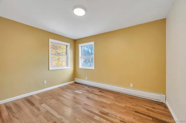 a view of an empty room and wooden floor