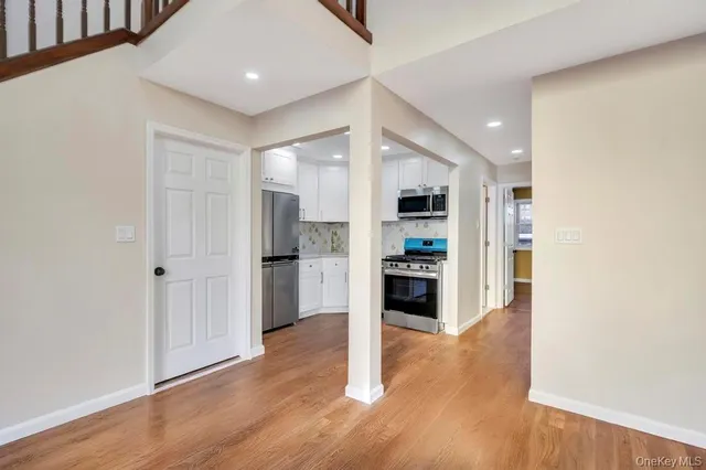 a kitchen with a stove a refrigerator and a microwave