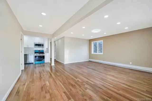 a view of kitchen with sink and refrigerator