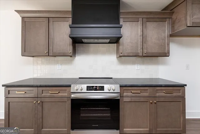 a stove top oven sitting inside of a kitchen