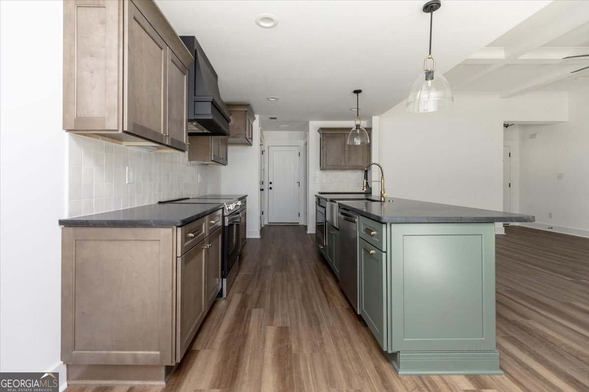 506 New Hope Drive Perry, GA 31069 - Photo 16 of 51 a kitchen with stainless steel appliances a stove a sink and a refrigerator