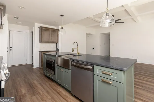 a kitchen with stainless steel appliances granite countertop a sink a stove and oven